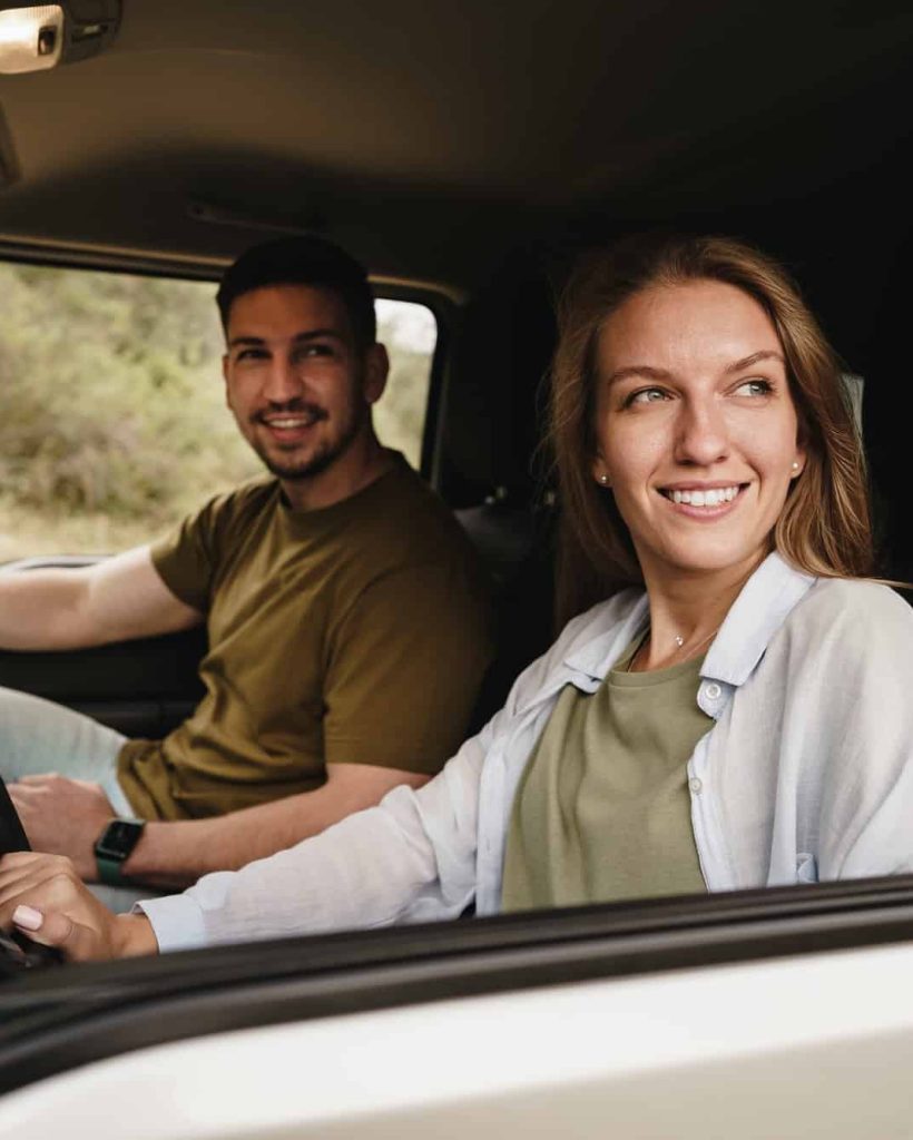 beautiful-young-couple-sitting-on-front-passenger-seats-and-driving-a-car-1.jpg