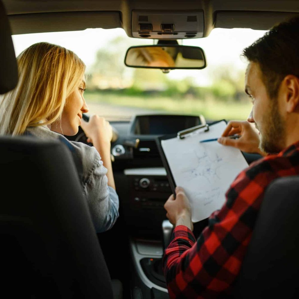 instructor-helps-woman-to-drive-the-car-4.jpg