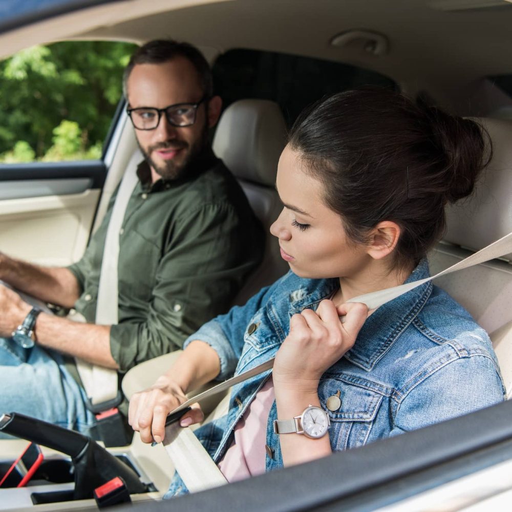 student-fastening-seat-belt-in-car-during-driving-test-1.jpg